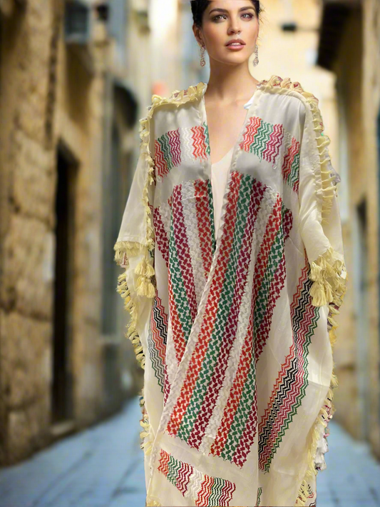 Woman wearing a colorful palestinian keffiyeh embroidered dress with a blurred background