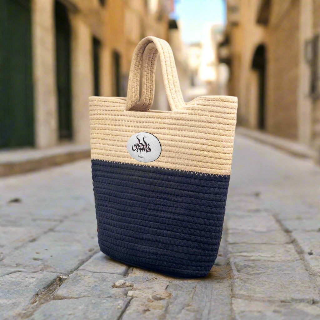 Handmade Woven Bag that is blue and beige with inscription "Palestine" in Arabic