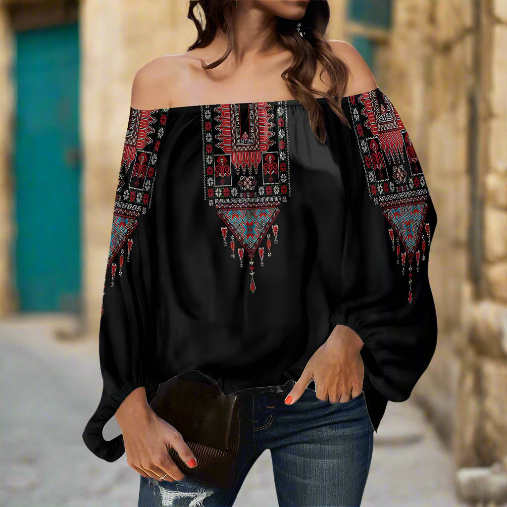 A woman wearing a Palestinian Tatreez Off-shouldered chiffon blouse