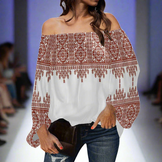 Woman wearing a Palestinian Tatreez casual chiffon long sleeves blouse that is Red and White. 