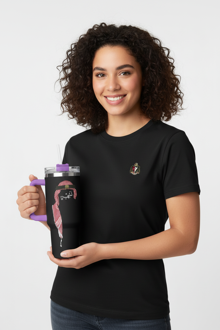 Woman holding a black mug with a design on a white background