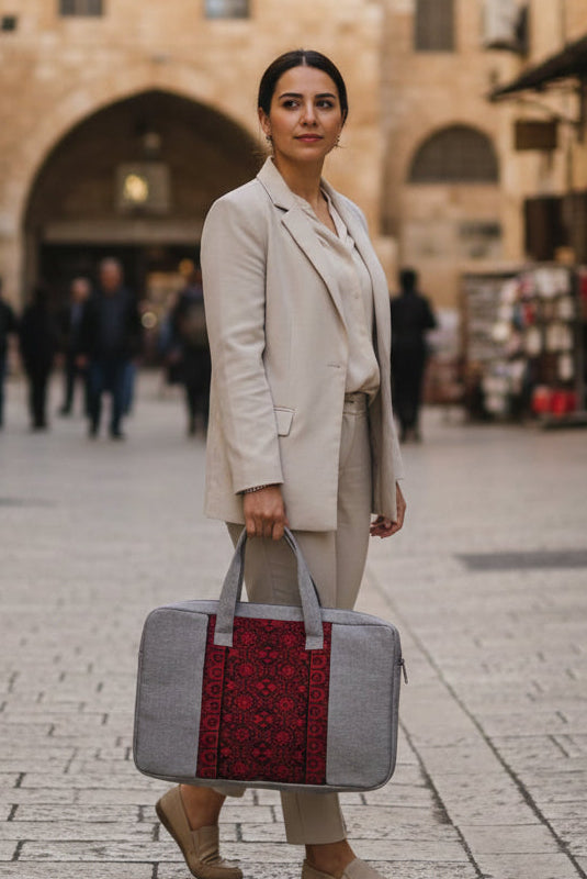 Woman holding a tatreez bag in an urban setting