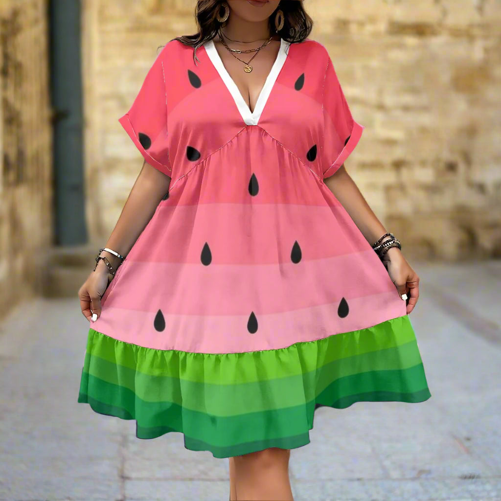 Person wearing a watermelon-themed dress against a textured wall.