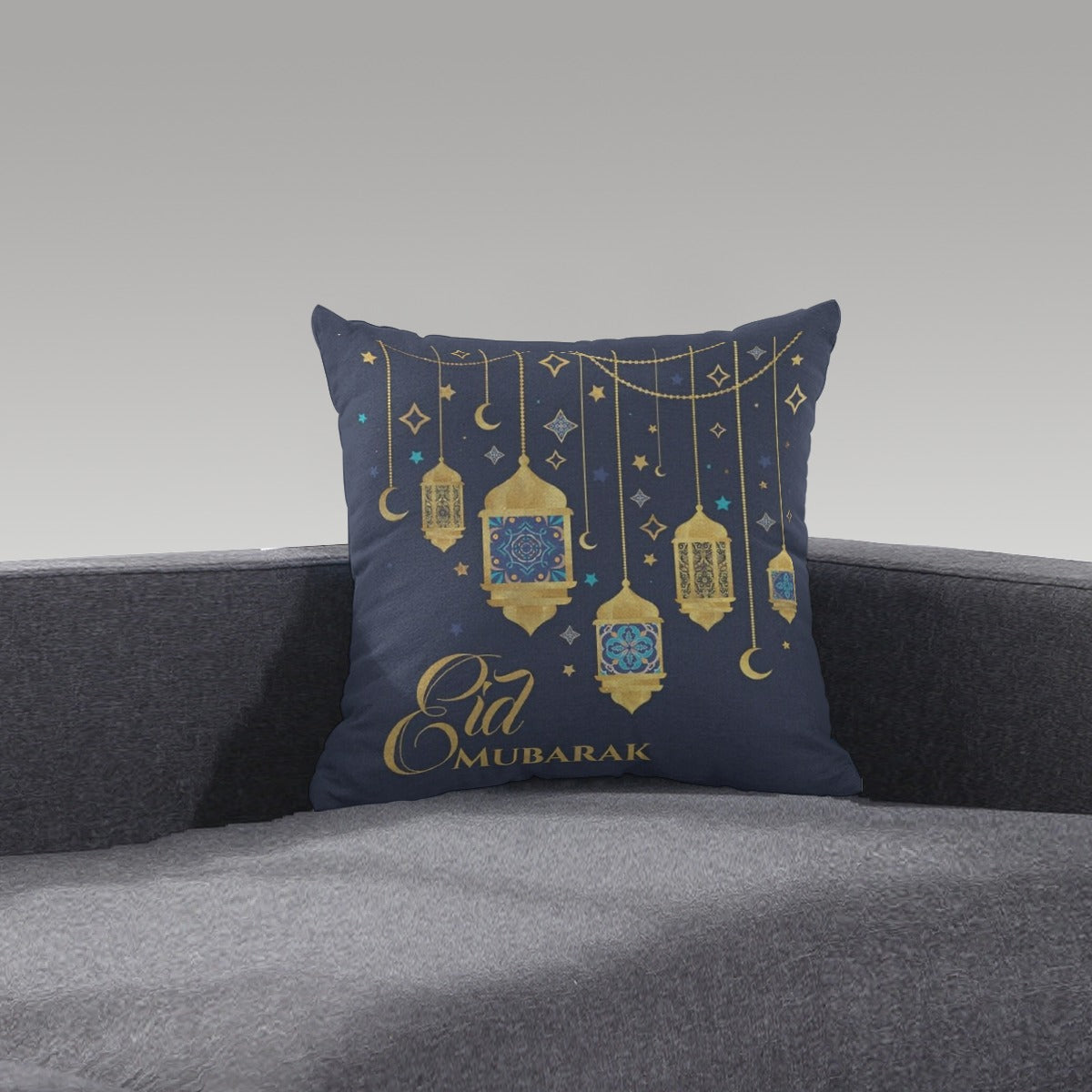 A Home Decor Arabian cushion with "Eid Mubarak" on it and Lanterns on a sofa. 